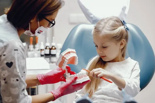 young child at dentist brushing teeth young child at dentist brushing teeth