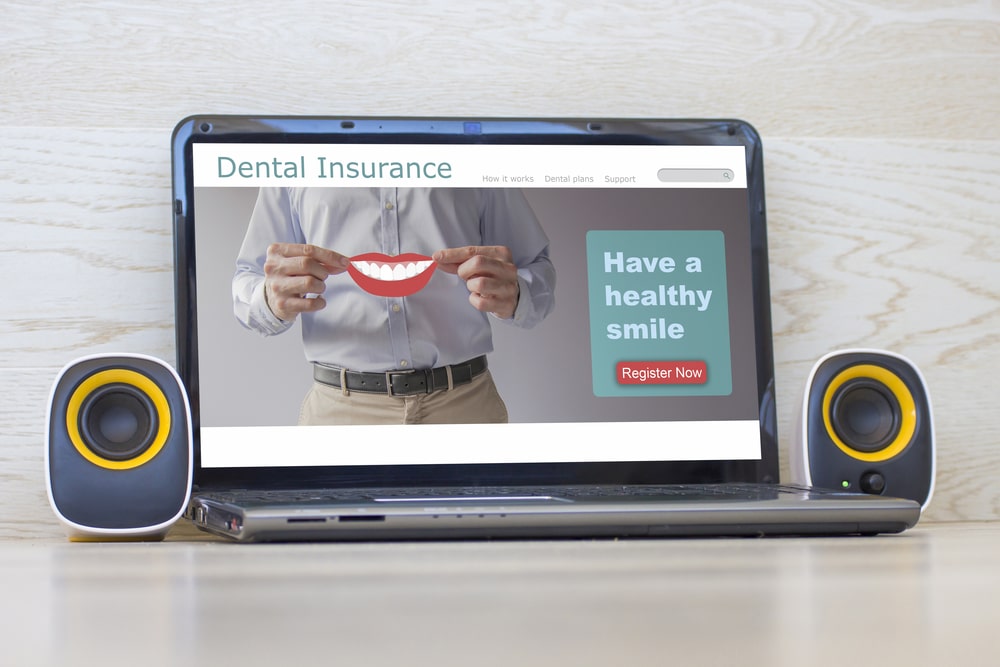 Close-up view of laptop with dental insurance plan website on screen